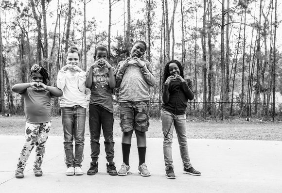 Group of kids making a heart with their hands