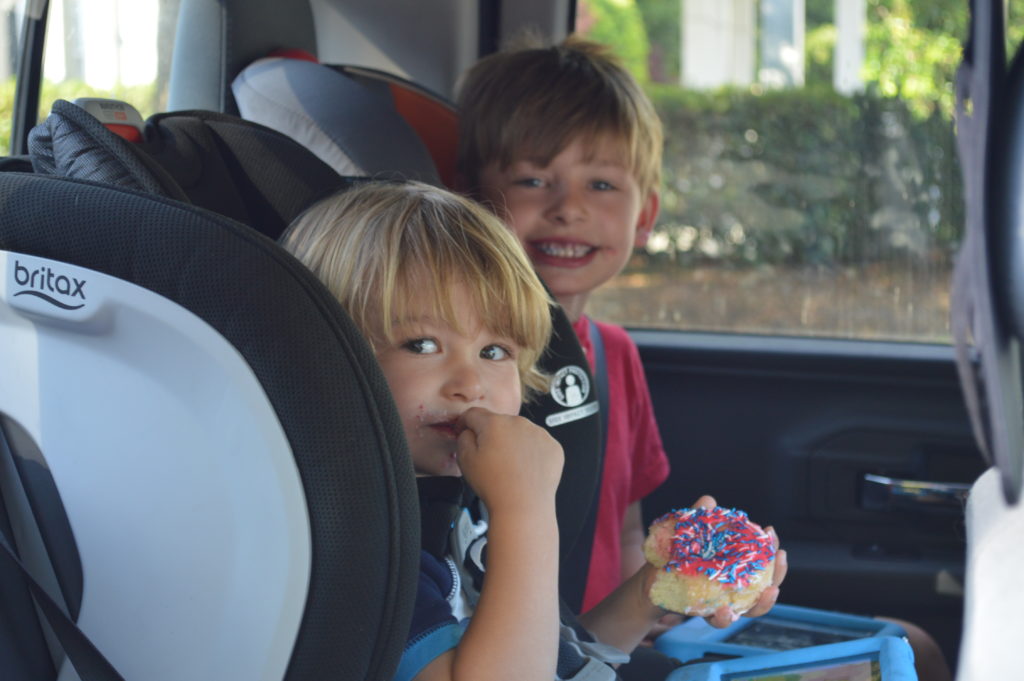 Kids happily eating treats in the car